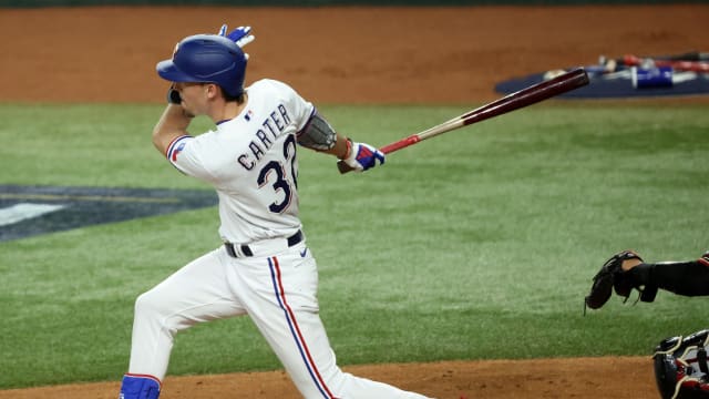 Oct 27, 2023; Arlington, TX, USA; Texas Rangers center fielder Evan Carter (32) hits a RBI double during the first inning in game one of the 2023 World Series against the Arizona Diamondbacks at Globe Life Field. Mandatory Credit: Kevin Jairaj-USA TODAY Sports